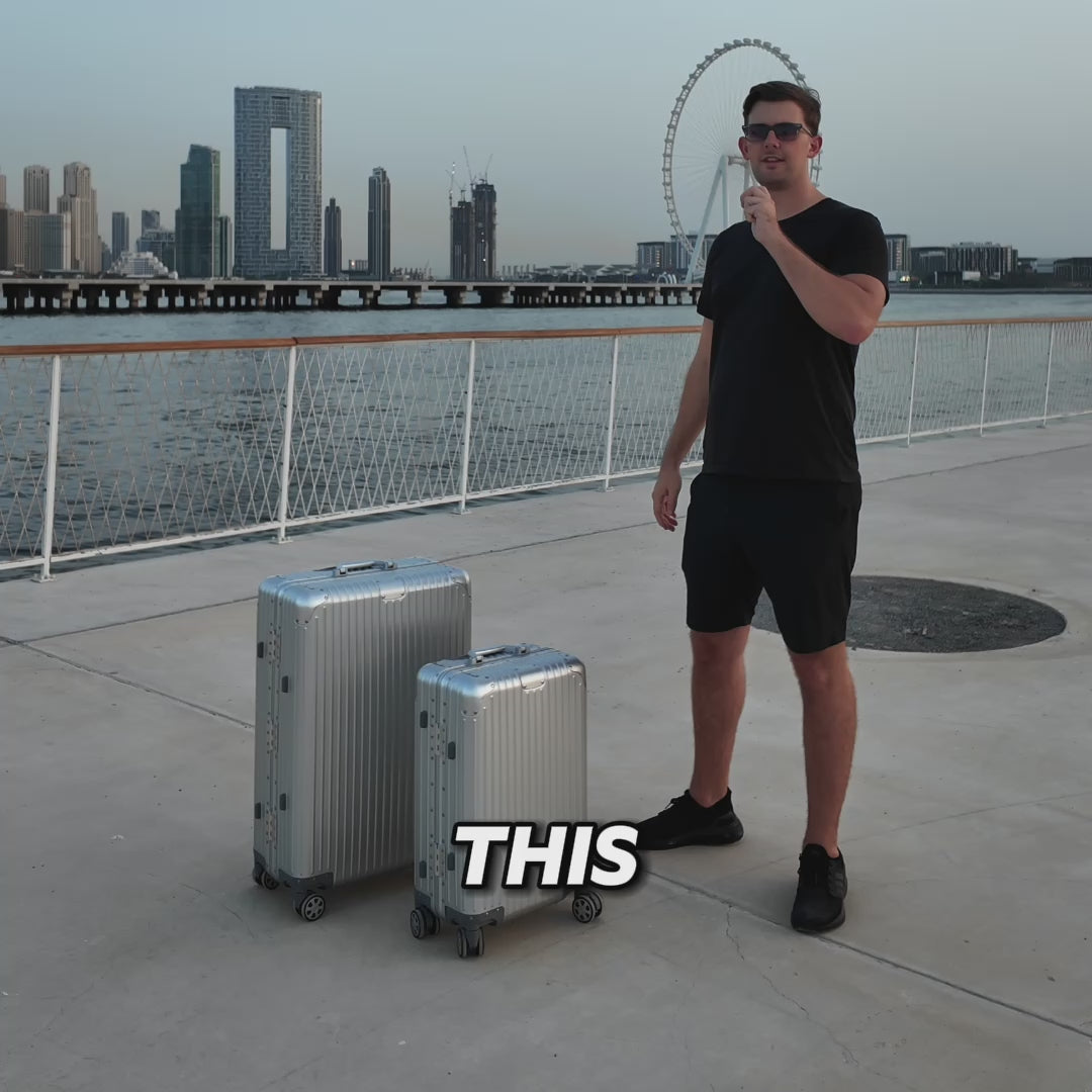 Traveler with silver aluminum suitcases